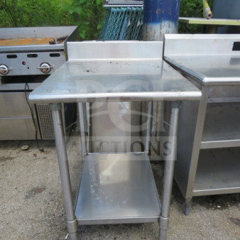 Eagle stainless steel table with under shelf and backsplash, 24x30x38.5 inches. Slight wear, industrial kitchen use.