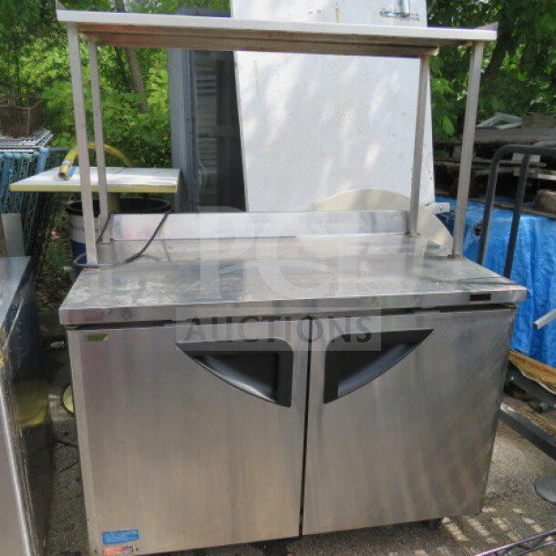 Turbo Air TWR-48SD-N 2 Door Worktop Refrigerator with stainless steel overshelf, on casters, includes 2 racks. 48x30x64 inches.