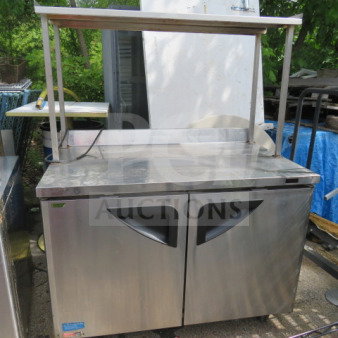 Turbo Air TWR-48SD-N 2 Door Worktop Refrigerator with stainless steel overshelf, on casters, includes 2 racks. 48x30x64 inches.