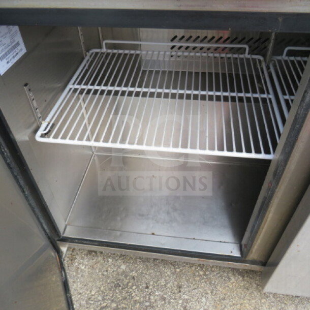Migali C-U48R-HC 2 Door Worktop Refrigerator with two racks, on casters, 115V, stainless steel interior, model tag visible.