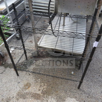 Black Metro shelf with 3 wire shelves, dimensions 36x14x36 inches, made by Metro, minor wear visible, suitable for storage.