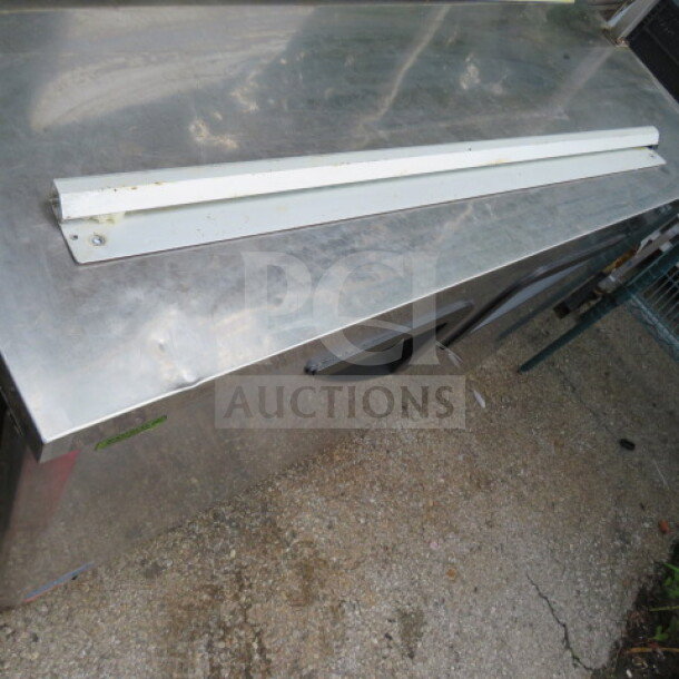 36-inch ticket rail, white, metal, with slight wear, mounted on stainless steel surface. Ideal for commercial use.