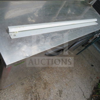 36-inch ticket rail, white, metal, with slight wear, mounted on stainless steel surface. Ideal for commercial use.