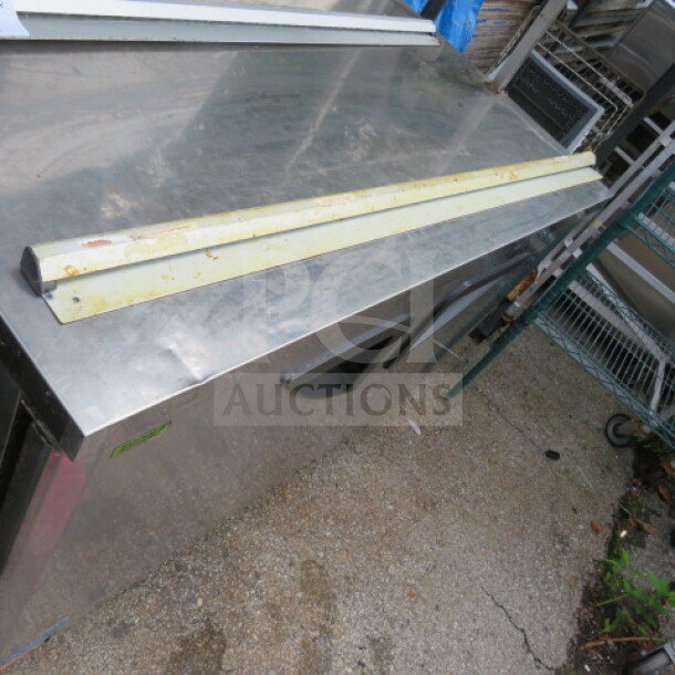 Metal 48-inch ticket rail, slightly rusted, used condition, placed on a stainless steel surface.