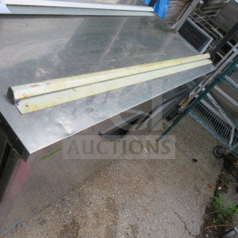 Metal 48-inch ticket rail, slightly rusted, used condition, placed on a stainless steel surface.