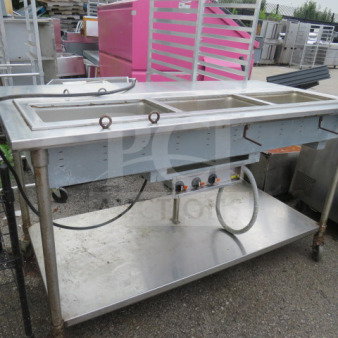 Stainless steel steam table with three wells, SS undershelf, on casters, measures 72x36x40 inches, slight wear visible.