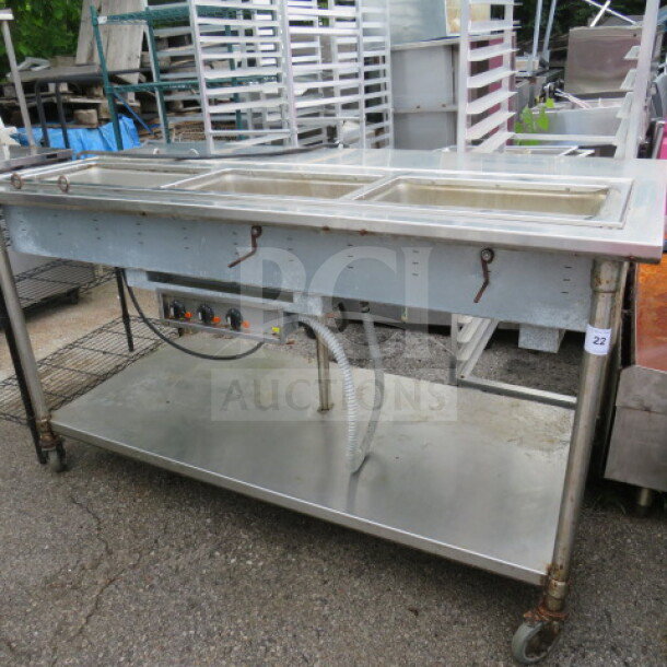 Stainless steel 3-well steam table with under shelf, on casters, dimensions 72x36x40, used condition, some wear.