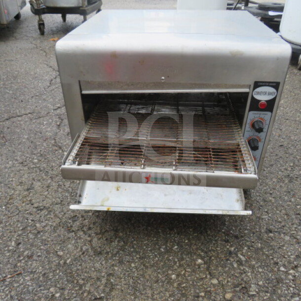 Omcan TS-7000 infrared conveyor baker oven, stainless steel, 240V, with control dials, used condition, working when removed.