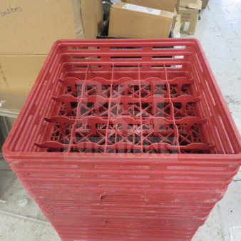Red 25-hole dishwasher rack, model 2XBID, stacked and in good condition, ideal for organizing kitchenware.