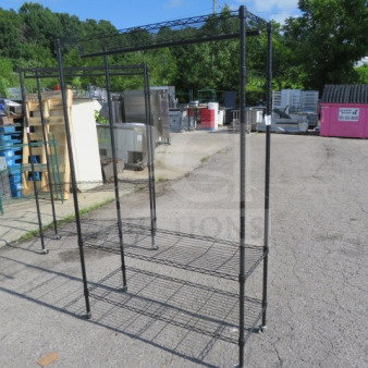 One black Metro shelf with three wire shelves, coat rack, hooks, and casters; dimensions 47x18x75 inches.