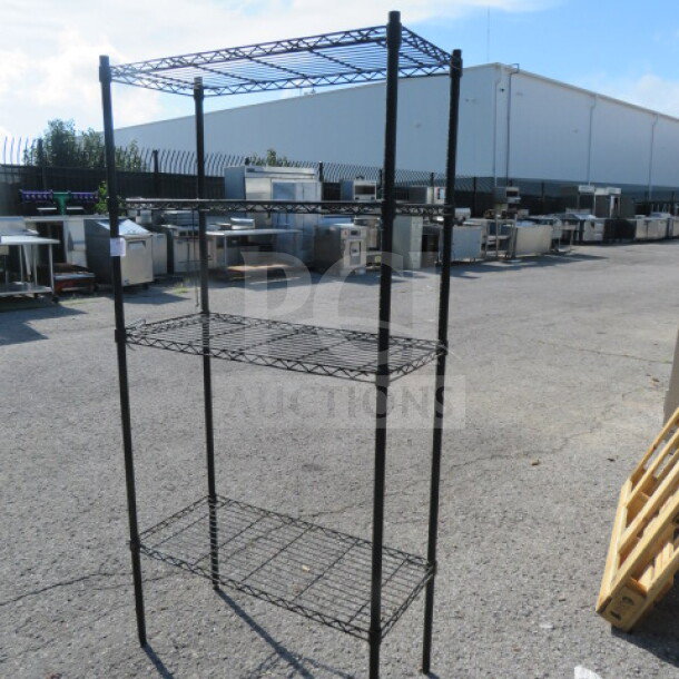 Black Metro shelf with 4 wire shelves, 36x16x73 inches. Sturdy metal construction, ideal for storage and display.