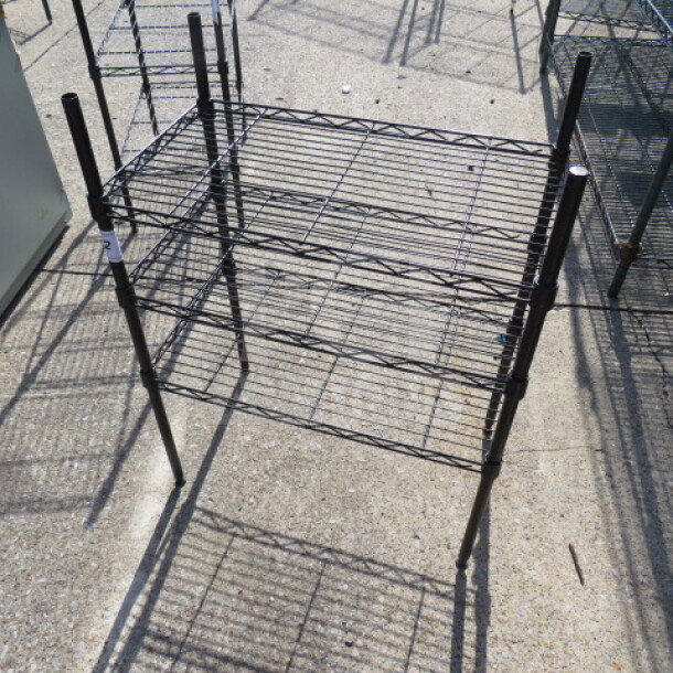 Black Metro shelf with three wire shelves, dimensions 23.5x13.5x31 inches, good condition.