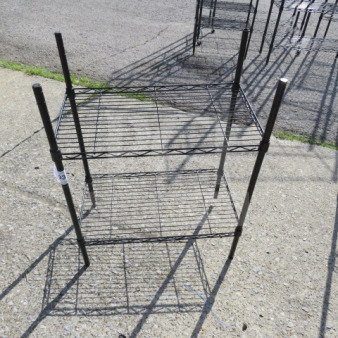 Black Metro shelf with two wire shelves, measuring 23.5x13.5x31 inches. Good condition, sturdy metal frame.