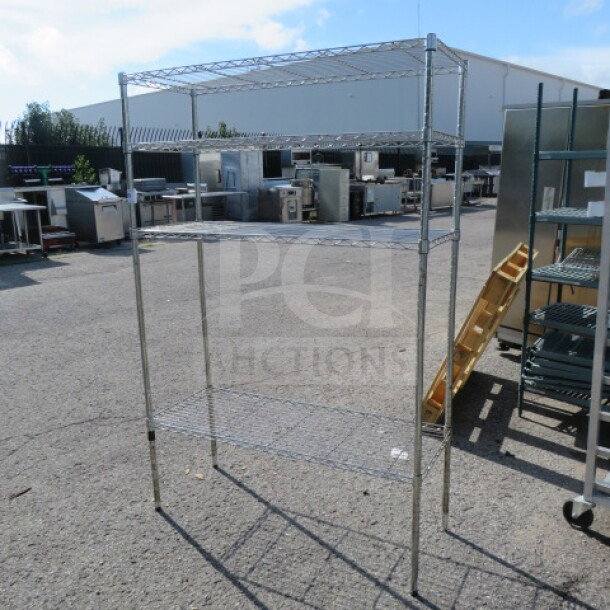 Metro shelf unit with 4 wire shelves, dimensions 48x18x72 inches, outdoor setting, used condition.