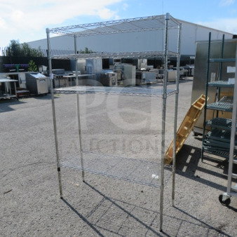 Metro shelf unit with 4 wire shelves, dimensions 48x18x72 inches, outdoor setting, used condition.