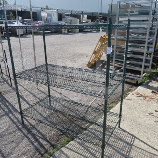 Green Metro shelf unit with 3 wire shelves, dimensions 48x24x52 inches, outdoor condition, visible brand marking.