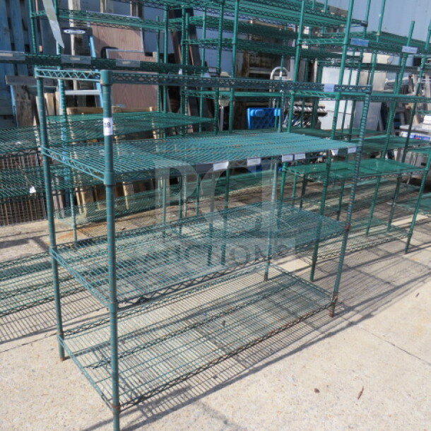 Green Metro shelf with 4 wire shelves, size 60x24x54.5 inches, used condition, ideal for storage and organization.
