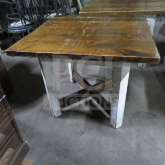 Heavy wooden table with a brown tabletop and white base, measuring 36x35x30 inches. Sturdy with visible wear.