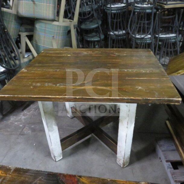 Heavy wooden table top on a wooden base, 41.5x35x30 inches. Rustic finish with visible wear, solid construction.