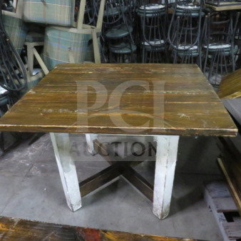 Heavy wooden table top on a wooden base, 41.5x35x30 inches. Rustic finish with visible wear, solid construction.