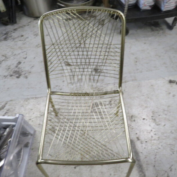 Gold metal chair with intricate wire pattern on seat and backrest. Sturdy design, excellent condition, model 2XBID.
