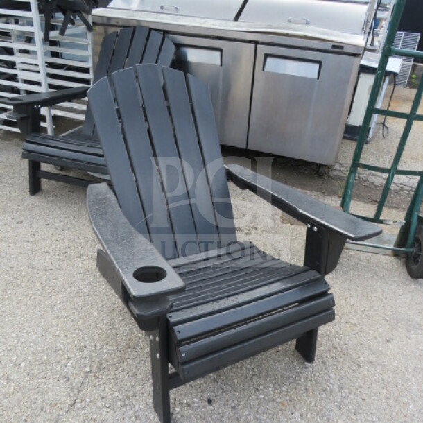 Black composite Adirondack chair with cup holder, featuring slatted design; excellent condition.