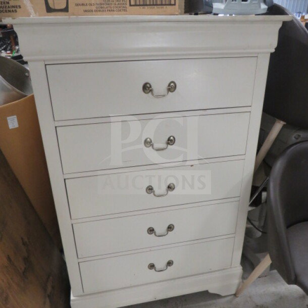 White wooden dresser with 5 drawers, 33x18x48 inches. Features brass handles, classic design. Good condition.