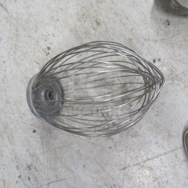 Stainless steel 20-quart whip attachment for a commercial mixer, in good condition, with sturdy wire construction.