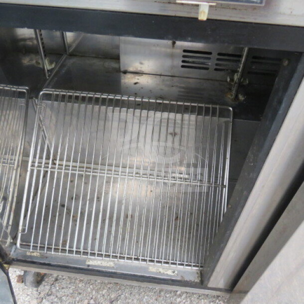 Turbo Air TUR-48SD-N 2 Door Worktop Refrigerator, includes 2 racks, on casters, visible interior detail, 115V, used condition.