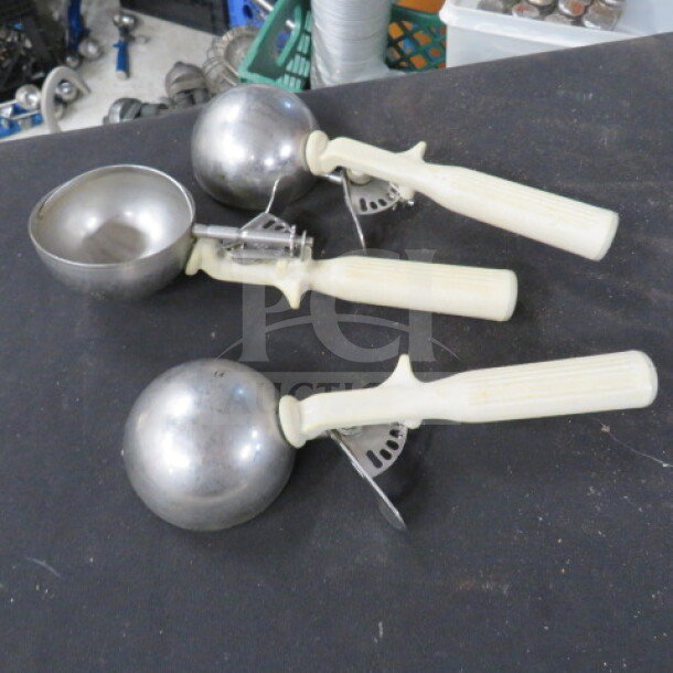 Three White Handle Dishers, metal scoops with cream handles, in good condition. Suitable for kitchen use, model 3XBID.