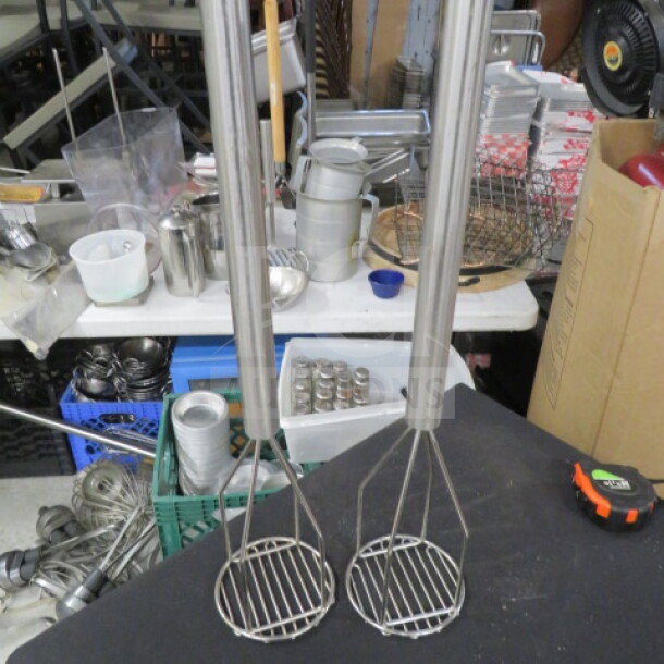 Stainless steel long handle masher, two available, durable design, ideal for heavy-duty kitchen use.