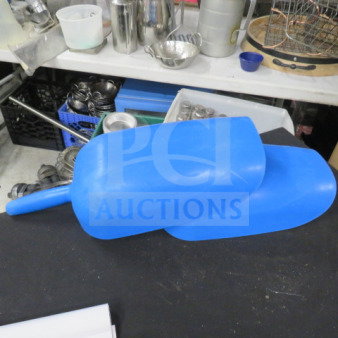 Blue poly scoop, large and durable, used condition. Ideal for bulk handling. No visible markings or brand tags.
