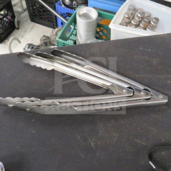 10-inch stainless steel tongs, lightly used, serrated edges, labeled "3XBID," on display table.
