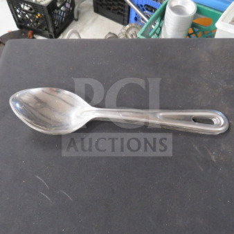 Stainless steel spoon with a sleek, polished finish. Features an ergonomic handle with a hanging hole. Model 3XBID.