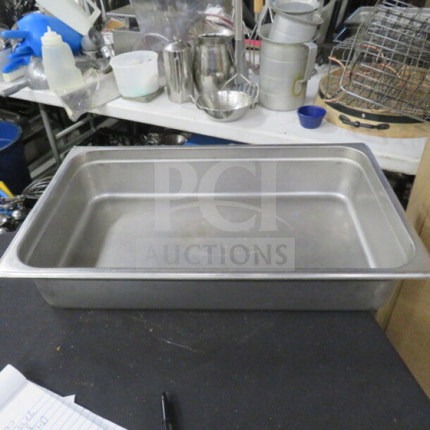 Full-size 4-inch deep hotel pan, stainless steel, used, rectangular shape, ideal for catering or food service.