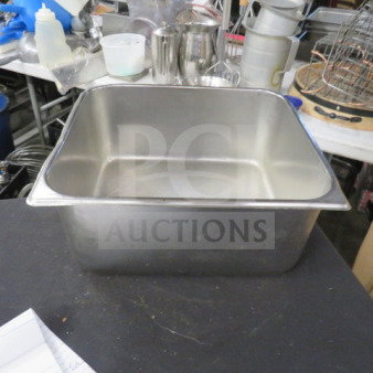 3/4 size 6-inch deep stainless steel hotel pan, used, with visible signs of wear. No tags or labels present.