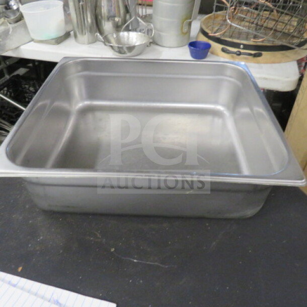 3/4 Size 4 Inch Deep Hotel Pan, stainless steel, used, ideal for catering or food service, visible slight wear.