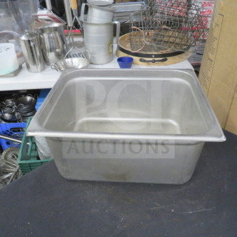 1/2 size, 6-inch deep hotel pan in stainless steel. Used condition with minor wear. Ideal for commercial kitchen use.