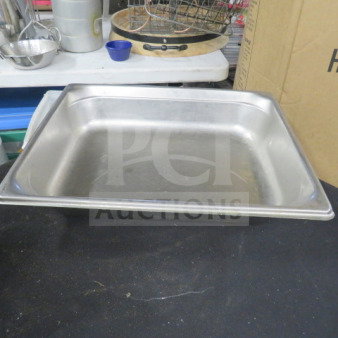 1/2 Size 4-inch deep stainless steel hotel pan, lightly used, ideal for food service. Marking: 2XBID.