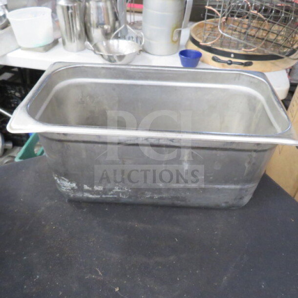 1/3 size hotel pan, 6-inch deep, stainless steel, visible wear, ideal for catering or food service needs.