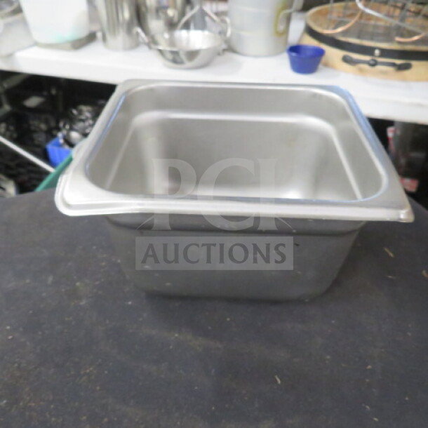 1/6 size 4-inch deep hotel pan, stainless steel, used condition, durable with slight wear, no visible labels or markings.