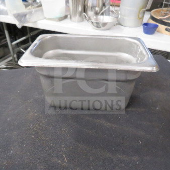 Stainless steel 1/9 size 4-inch deep hotel pan, used condition, ideal for commercial kitchen or catering use.
