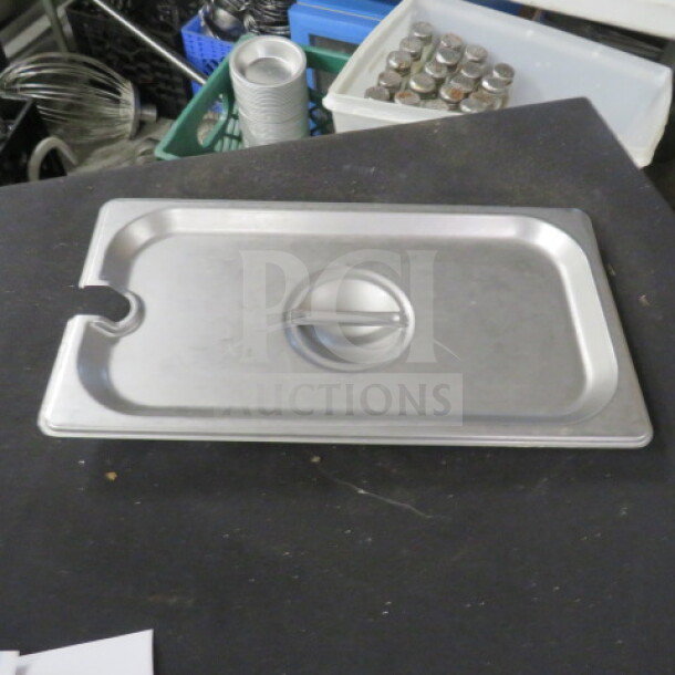 1/3 Size Stainless Steel Lid with handle, utensil notch. Lightly used condition, ideal for commercial kitchen use.