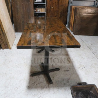 One 1-1/2 inch thick solid wood butcher block table top on dual pedestal base, dimensions 54x33x30, rustic finish.