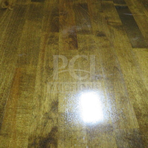 Solid wood butcher block table top, 1-1/2" thick, on a pedestal base. Dimensions: 42" x 32" x 30". Smooth polished surface.