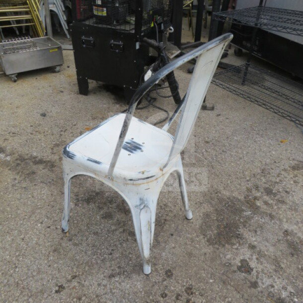 Vintage look white washed industrial metal chair, worn finish, sturdy construction, ideal for rustic decor or collectors.