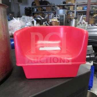 Red Cambro booster seat, model 100BC, durable plastic, gently used. Visible warning label on seat. Ideal for child seating.