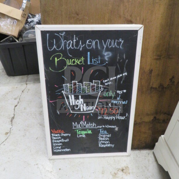 One 20x30 white wooden framed chalkboard with colorful writing and a bucket list theme, in good condition.
