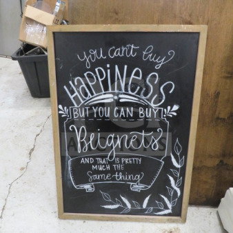 22x31 wooden framed chalkboard with decorative quote and leaf design. Used condition with visible handwriting.