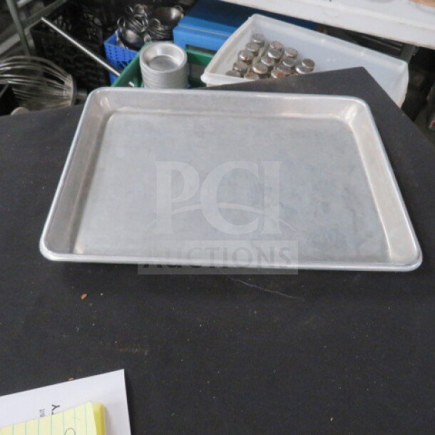 13x9.5 aluminum sheet pan in good condition. Rectangular with raised edges, suitable for baking and roasting.